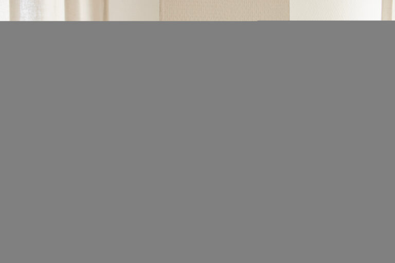 Hand adjusting a wall thermostat with digital display