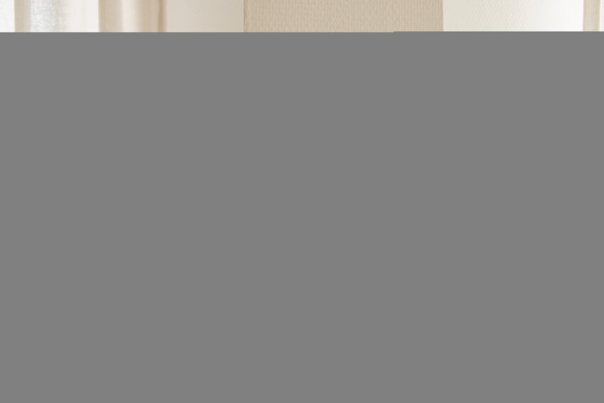 Hand adjusting a wall thermostat with digital display