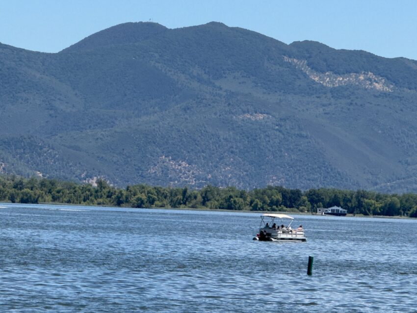 Pontoon boat on Clear Lake off Lakeport with Mount Konocti in the distance