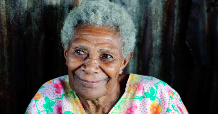 An older woman with gray hair smiles, file photo