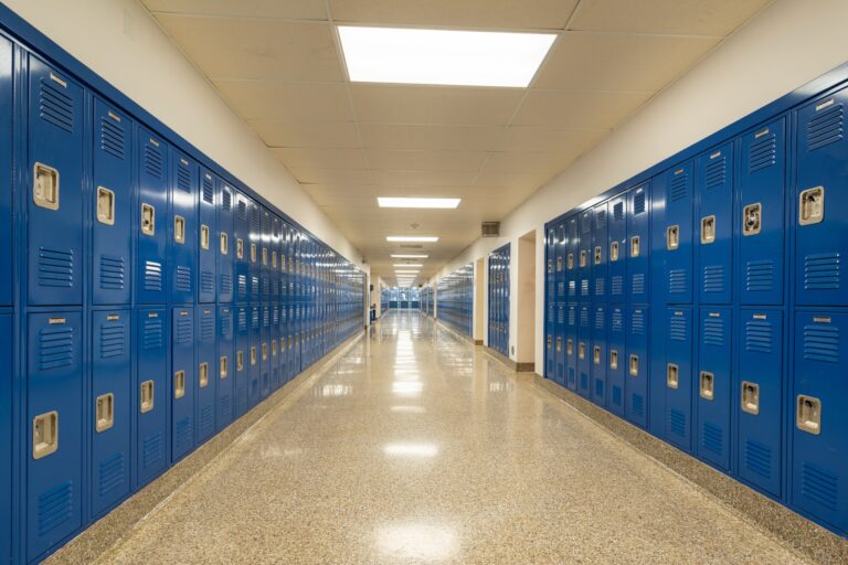 Empty school hallway with blue lockers
